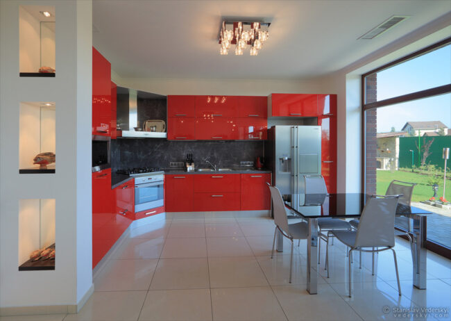 interior of the house, kitchen area, modern design in white and red colours. property photography