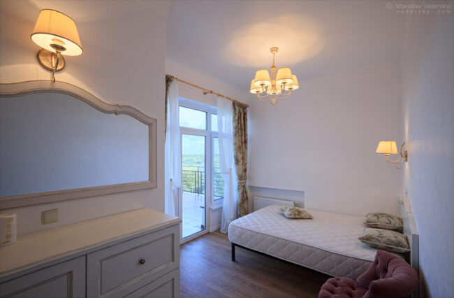 interior of the house, small bedroom with beautiful view, classical design in pastel colours. property photography