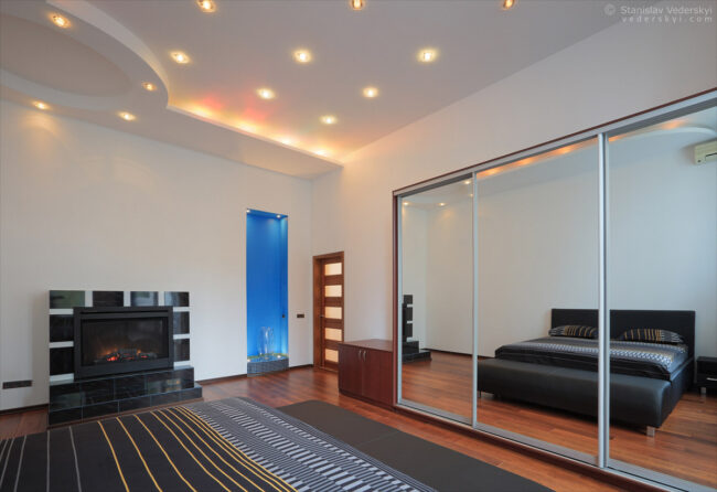 interior of the modern apartments, bedroom with big mirror, property photography