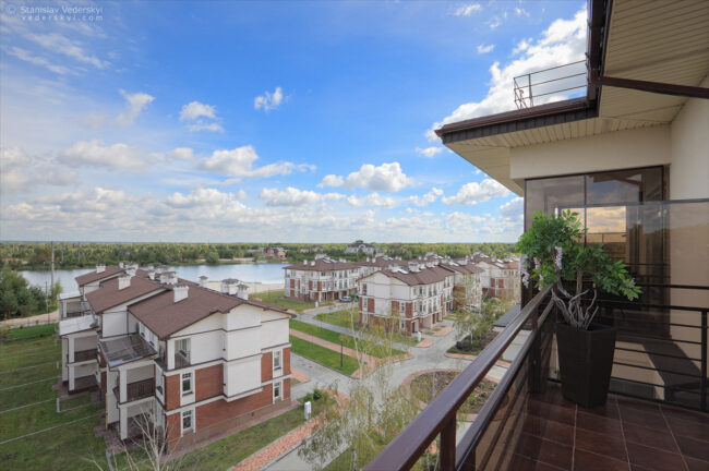 Modern cottage town near by the river at summer time. Exterior property photography