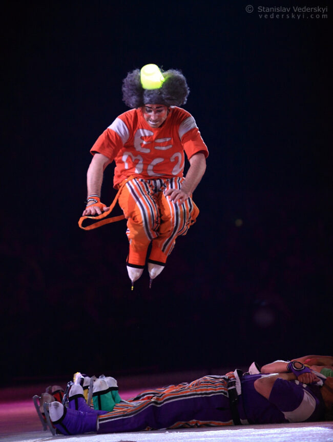 artist clown jumping over people in ice show