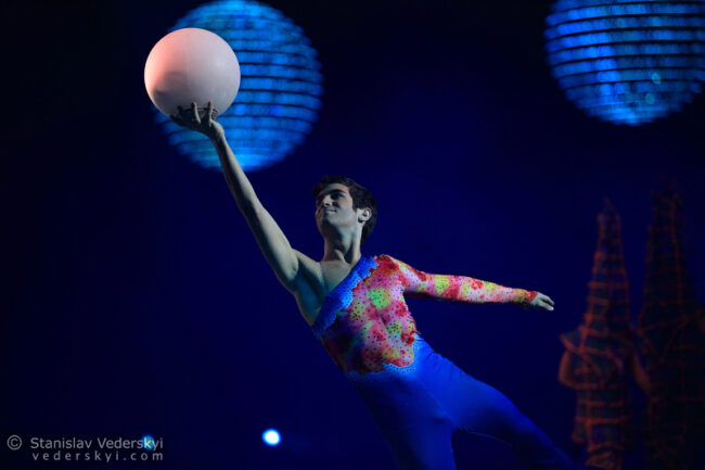 young man figure skater performing in ice show