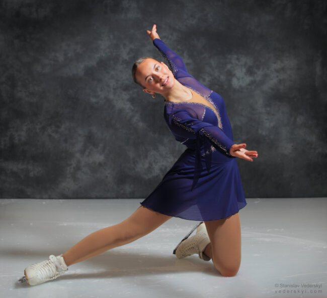 figure skating girl in posing dress art photosession on ice
