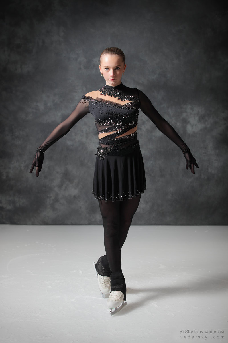figure skating girl in posing dress art photosession on ice