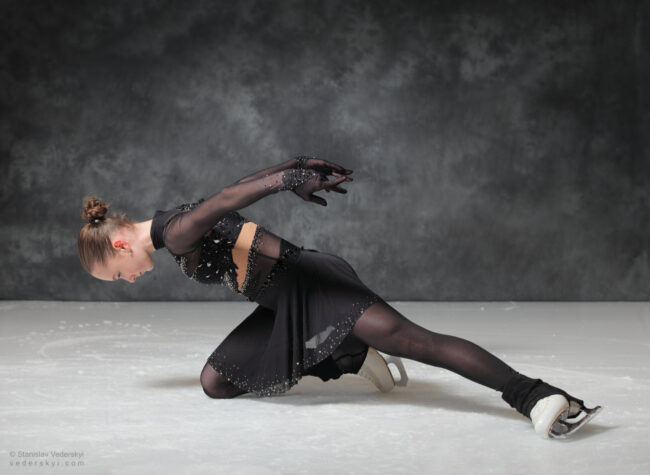 figure skating girl in posing dress art photosession on ice