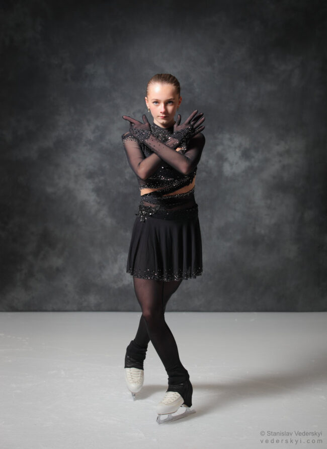 figure skating girl in posing dress art photosession on ice