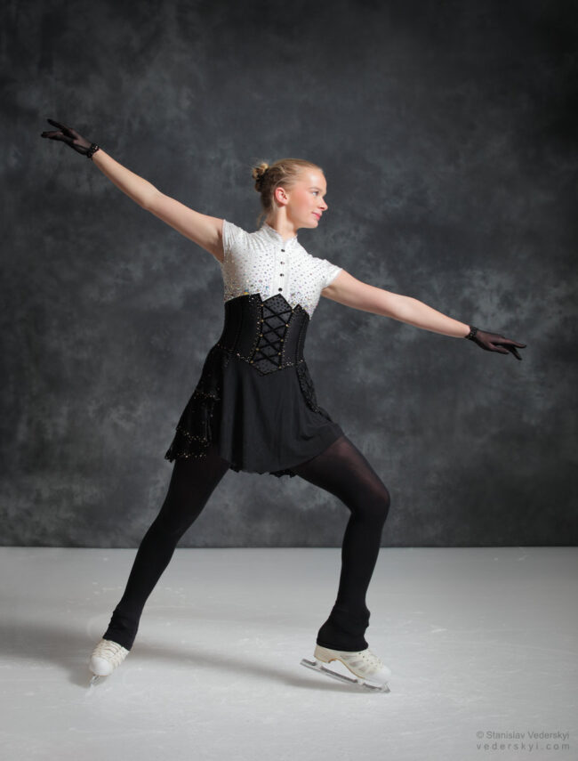 figure skating girl in posing dress art photosession on ice