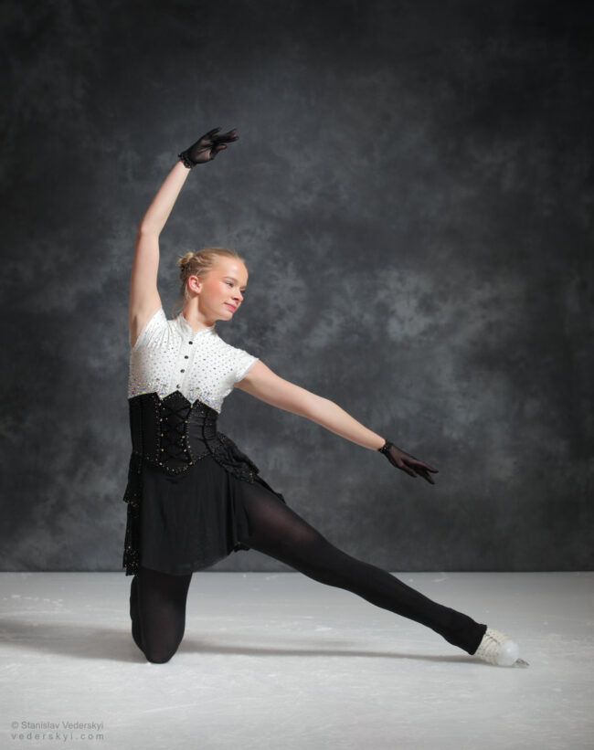 figure skating girl in posing dress art photosession on ice