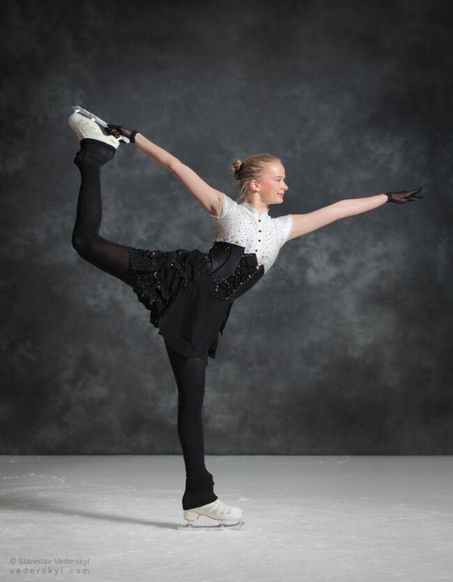 figure skating girl in posing dress art photosession on ice