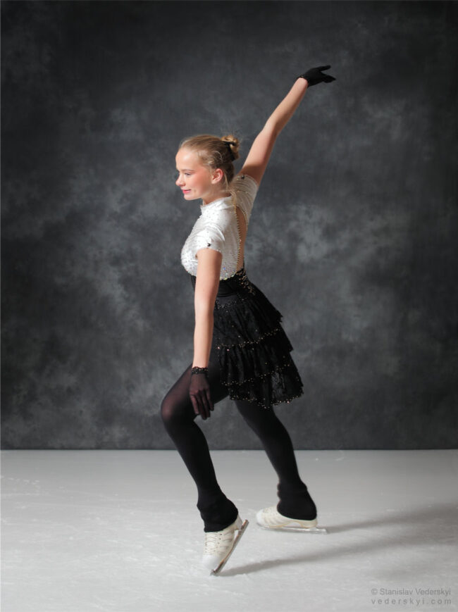 figure skating girl in posing dress art photosession on ice