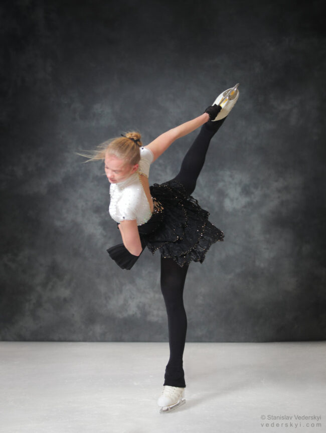 figure skating girl in posing dress art photosession on ice