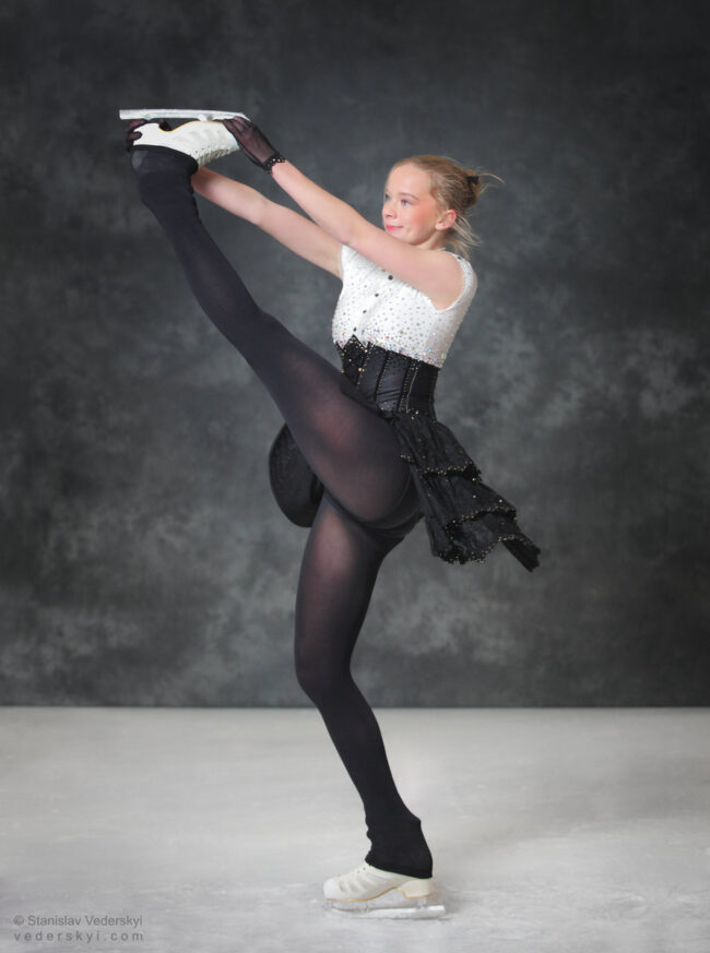 figure skating girl in posing dress art photosession on ice