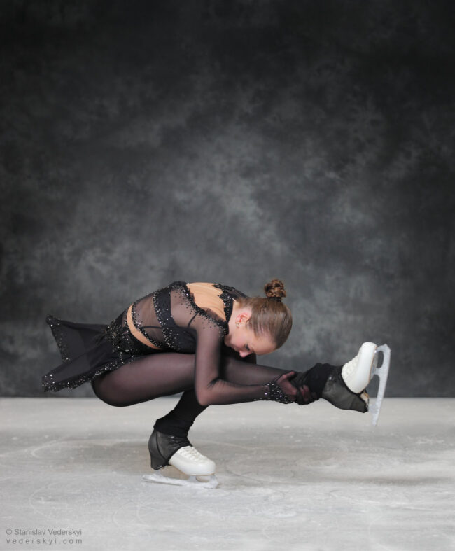 figure skating girl in posing dress art photosession on ice