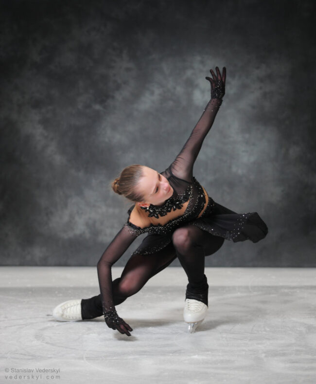 figure skating girl in posing dress art photosession on ice