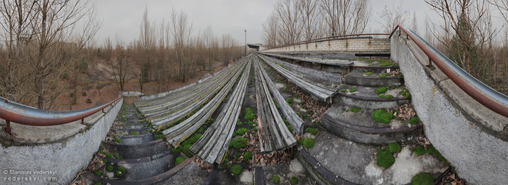 Pripyat-Stadium-1-1000 Chernobyl zone Panorama of abandoned stadium in ghost Pripyat town inside Chernobyl Exclusion zone