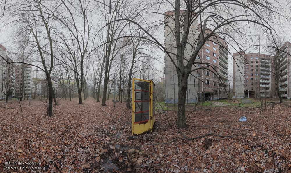 1-Pripyat Waiting For A Call-1000 Abandoned yard in Pripyat, Chernobyl Exclusion Zone, panoramic fine art photograph. Old phone booth in the center.
