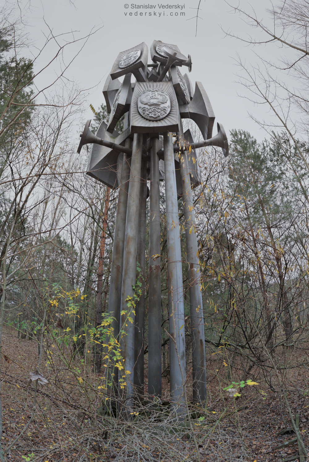 Pripyat-Monument-1-1000×1400 Chernobyl zone Multirow panorama shot in front of decayed Monument located in abandoned Pripyat ghost town of Chernobyl Exclusion zone, Ukraine.