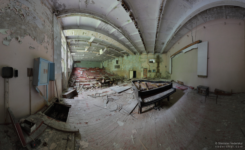 Pripyat-MusicSchool-1-1000 Chernobyl zone Empty concert hall with old broken grand piano inside abandoned music school of Pripyat ghost town in Chernobyl zone of alienation, Ukraine.